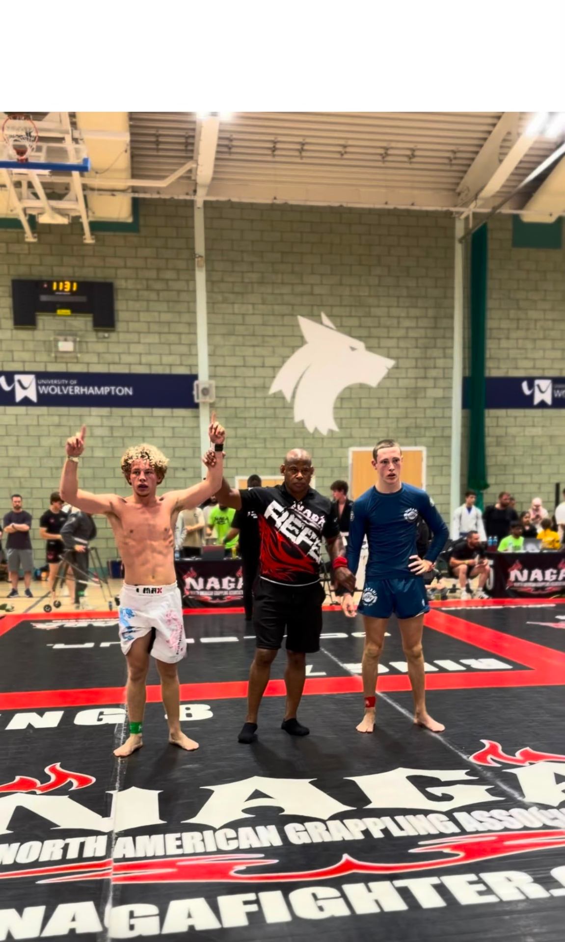 Referee raises the winner's hand at NAGA finals
