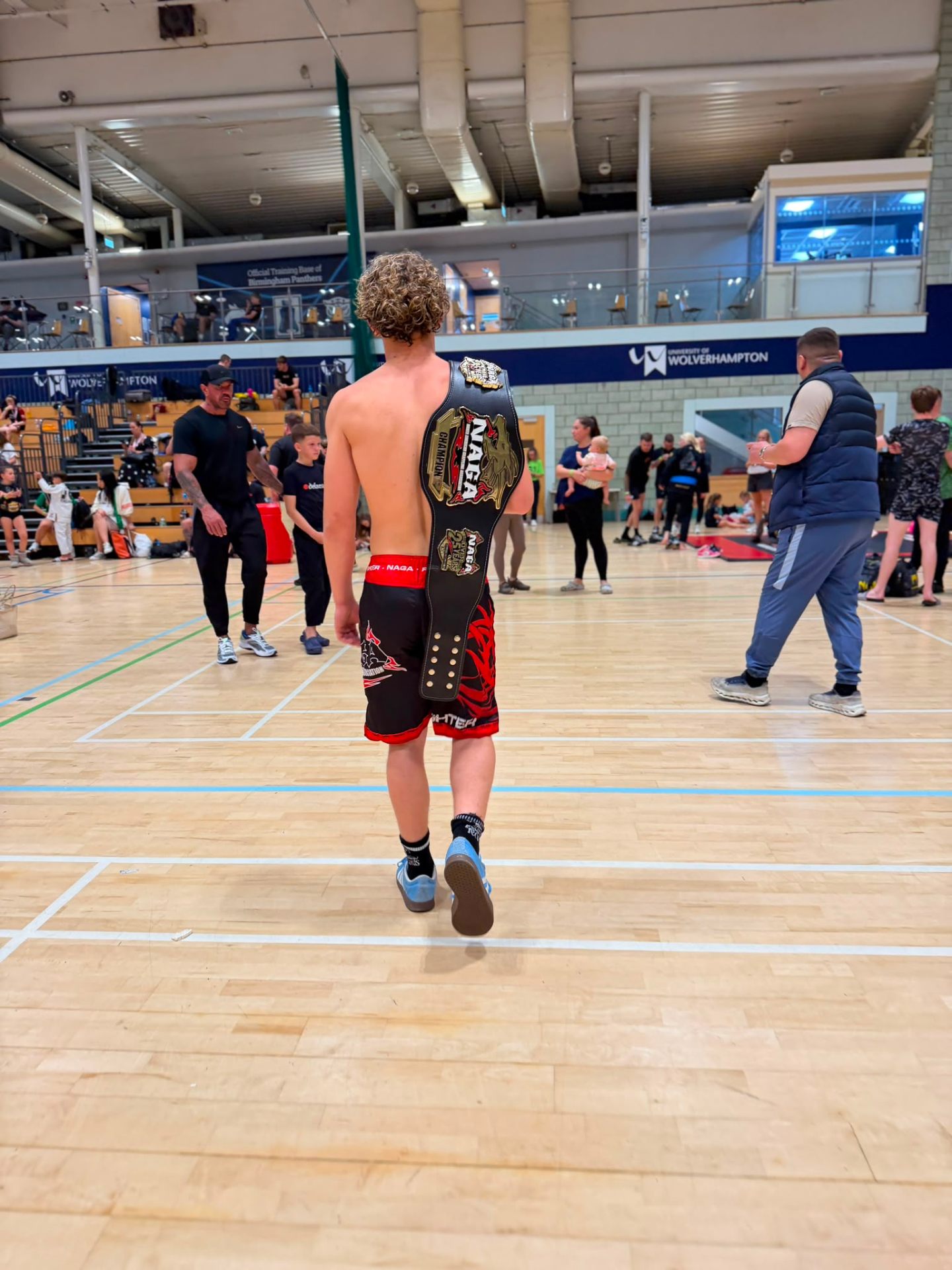 Walking through the gym with championship belt